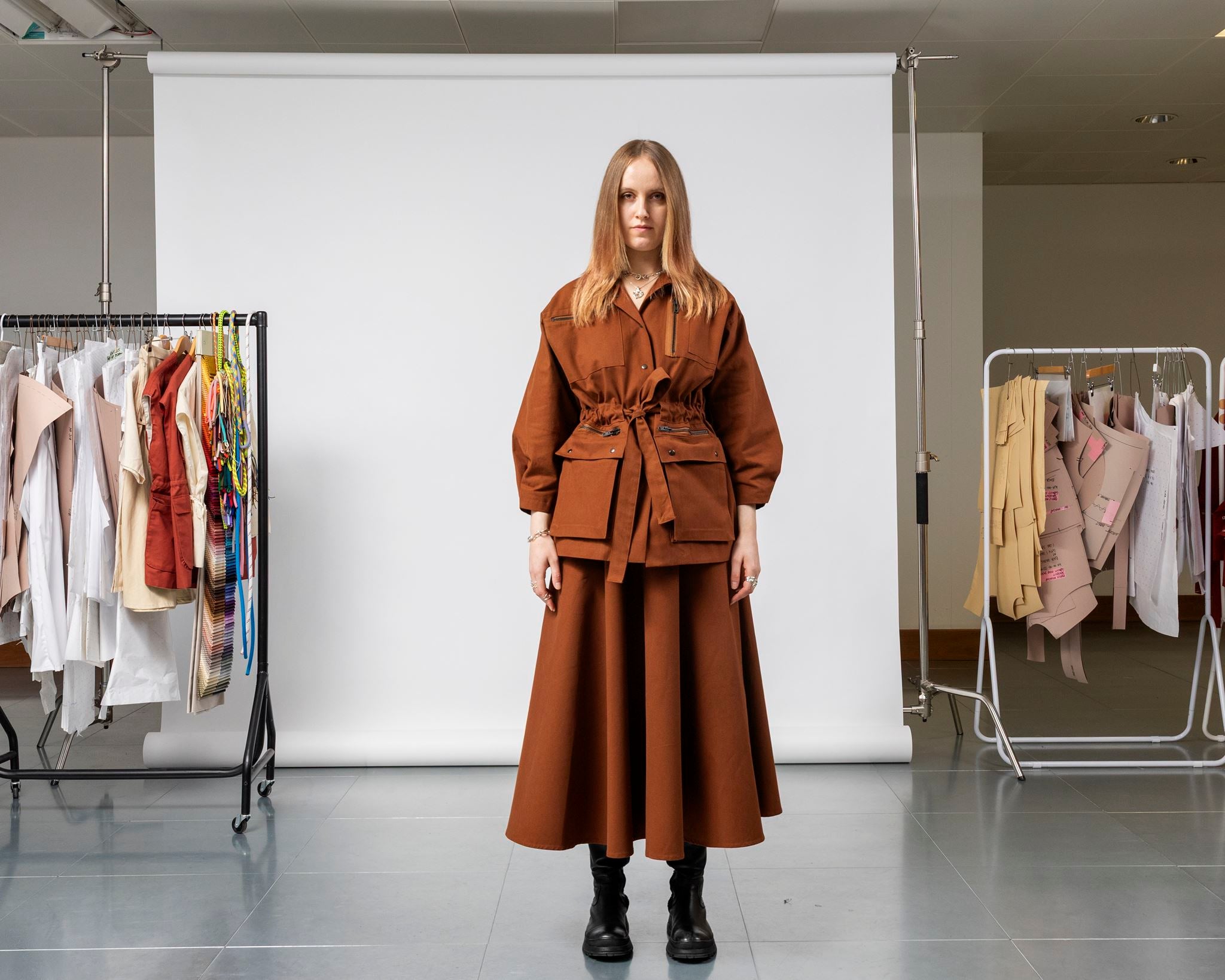 Emily Millichip Gravity Field Jacket in bronze heavyweight sanded canvas, front view showing the adjustable drawstring waist, oversized utility pockets, and cropped sleeves, styled with a matching skirt.