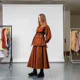 Emily Millichip Gravity Field jacket in bronze heavyweight sanded canvas, side view showing the belted waist, utility pockets, and sculptural sleeves