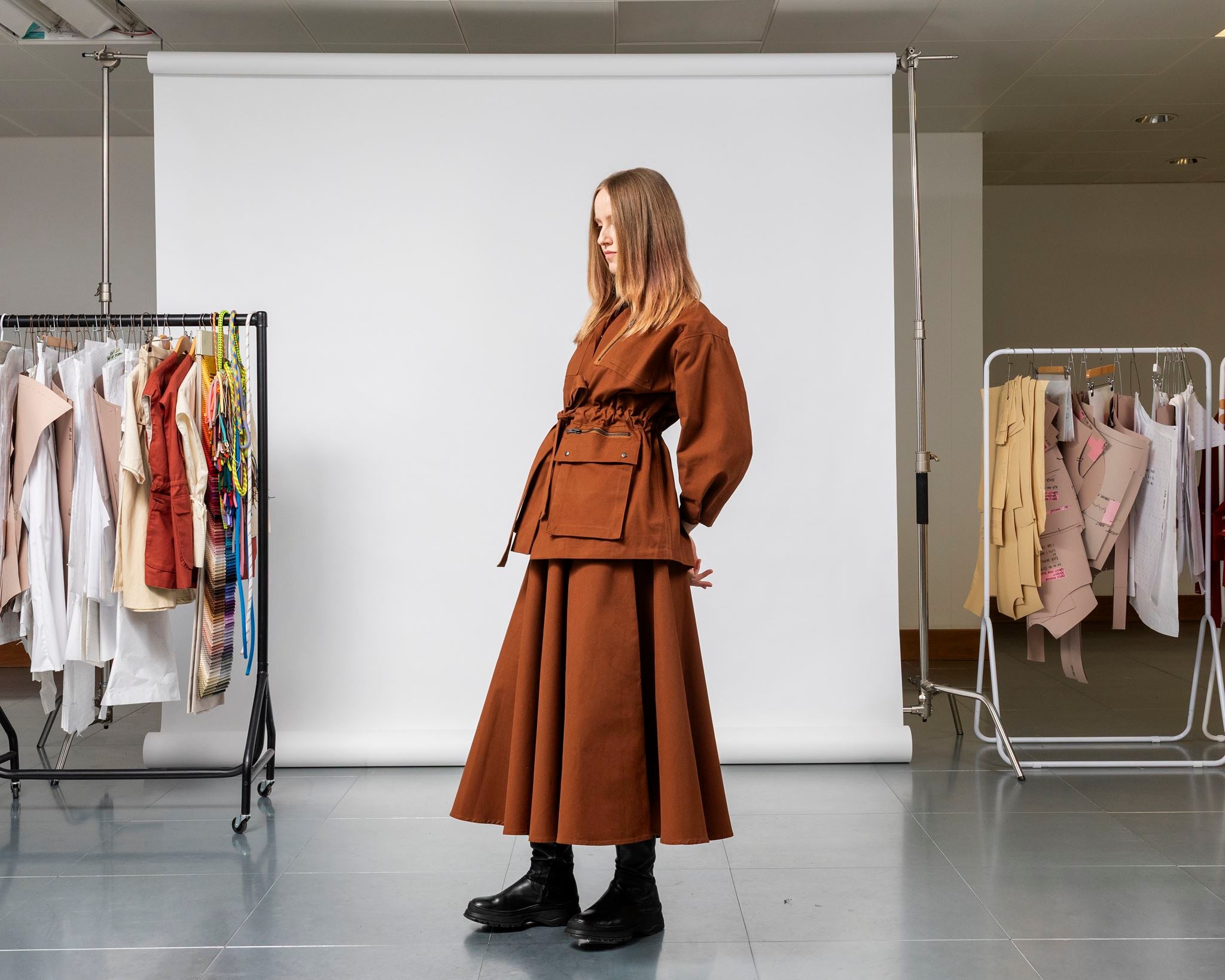 Emily Millichip Gravity Field jacket in bronze heavyweight sanded canvas, side view showing the belted waist, utility pockets, and sculptural sleeves