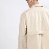 Back view of the Gravity Field Jacket in natural seeded cotton canvas with full-length sleeves