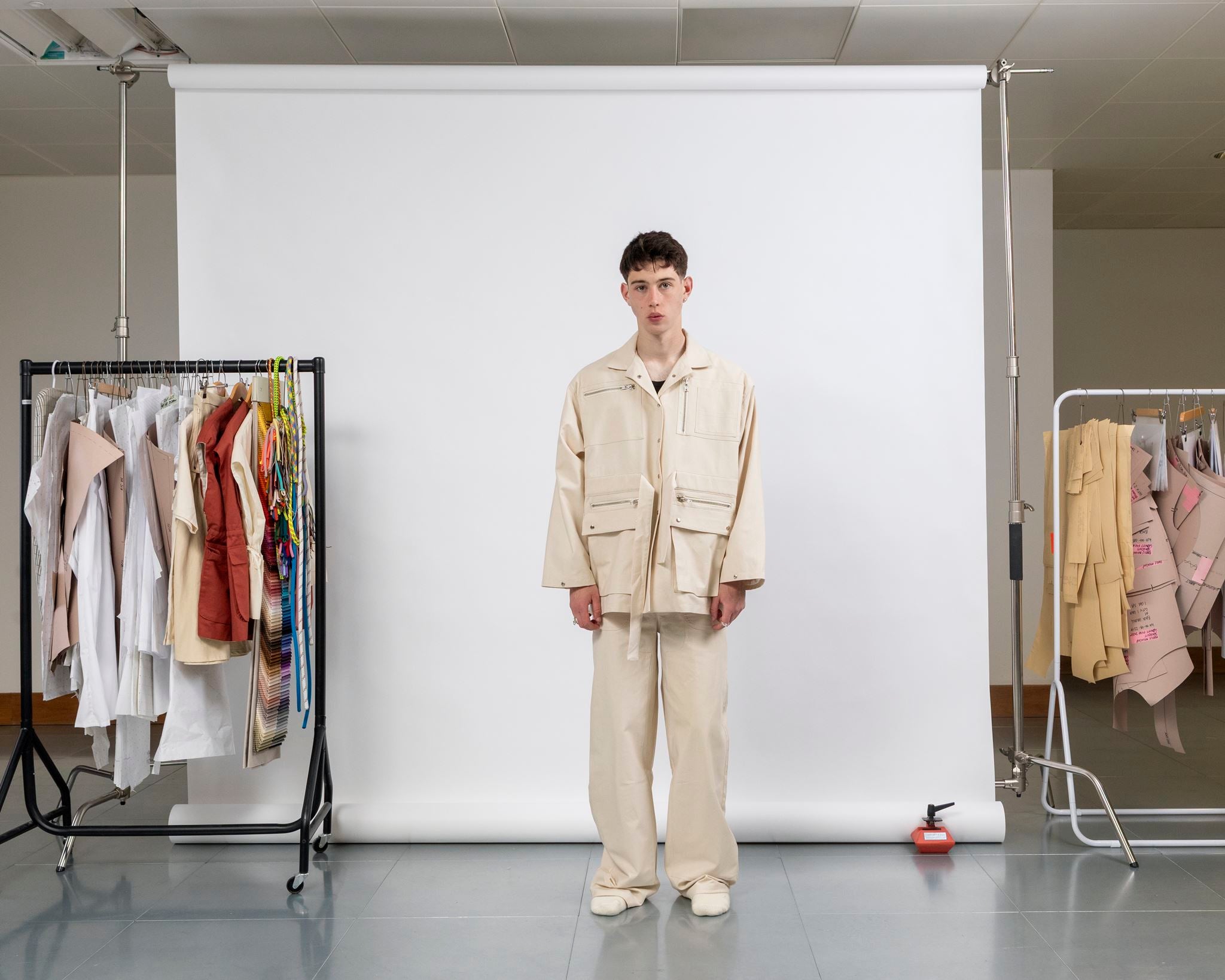 Front view of gravity field jacket in natural seeded canvas, worn loose and boxy