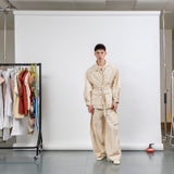 Gravity Field Jacket in natural seeded cotton canvas, worn cinched at the waist with full-length sleeves