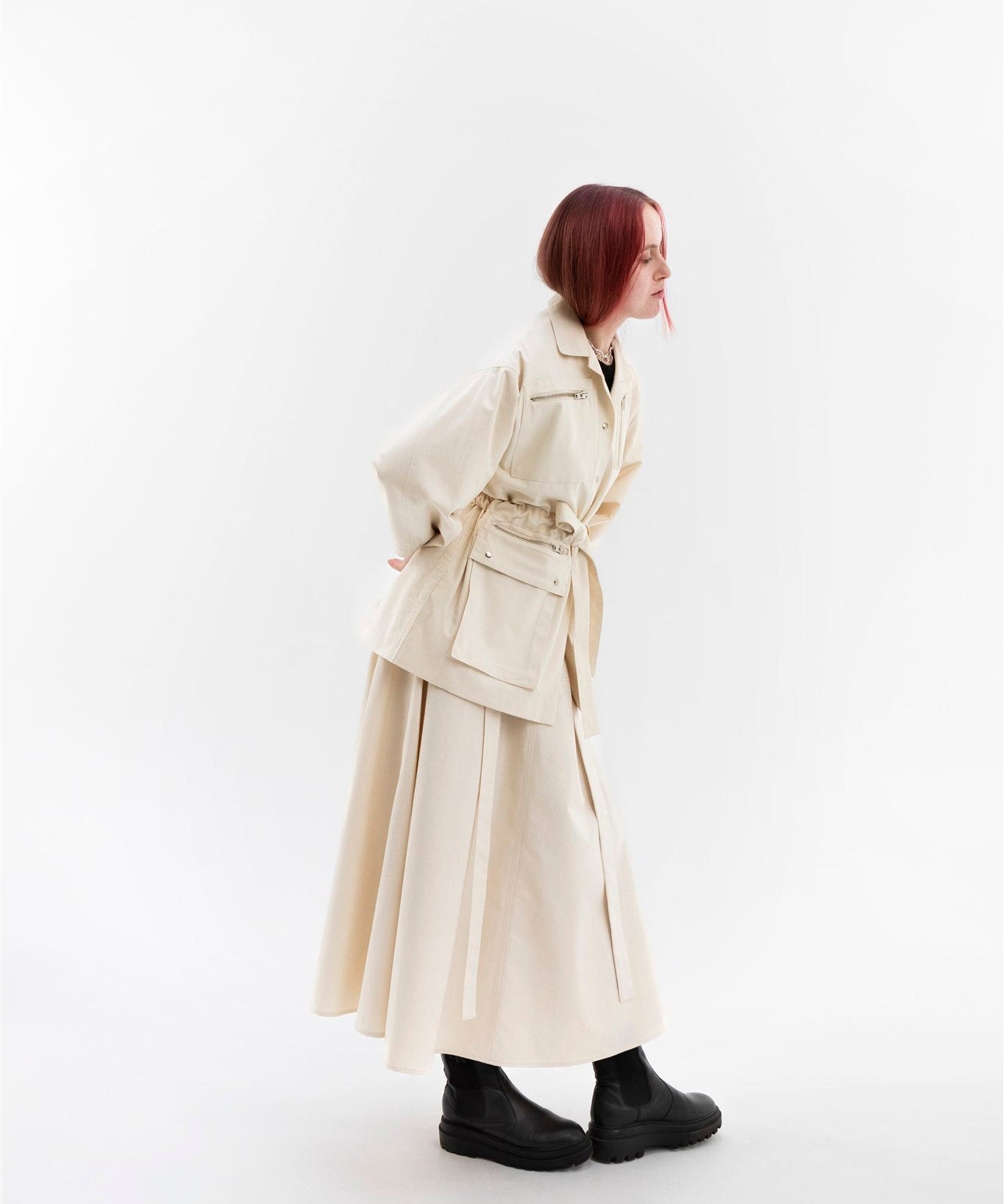 Gravity Field Jacket in natural seeded cotton canvas, worn cinched at the waist.