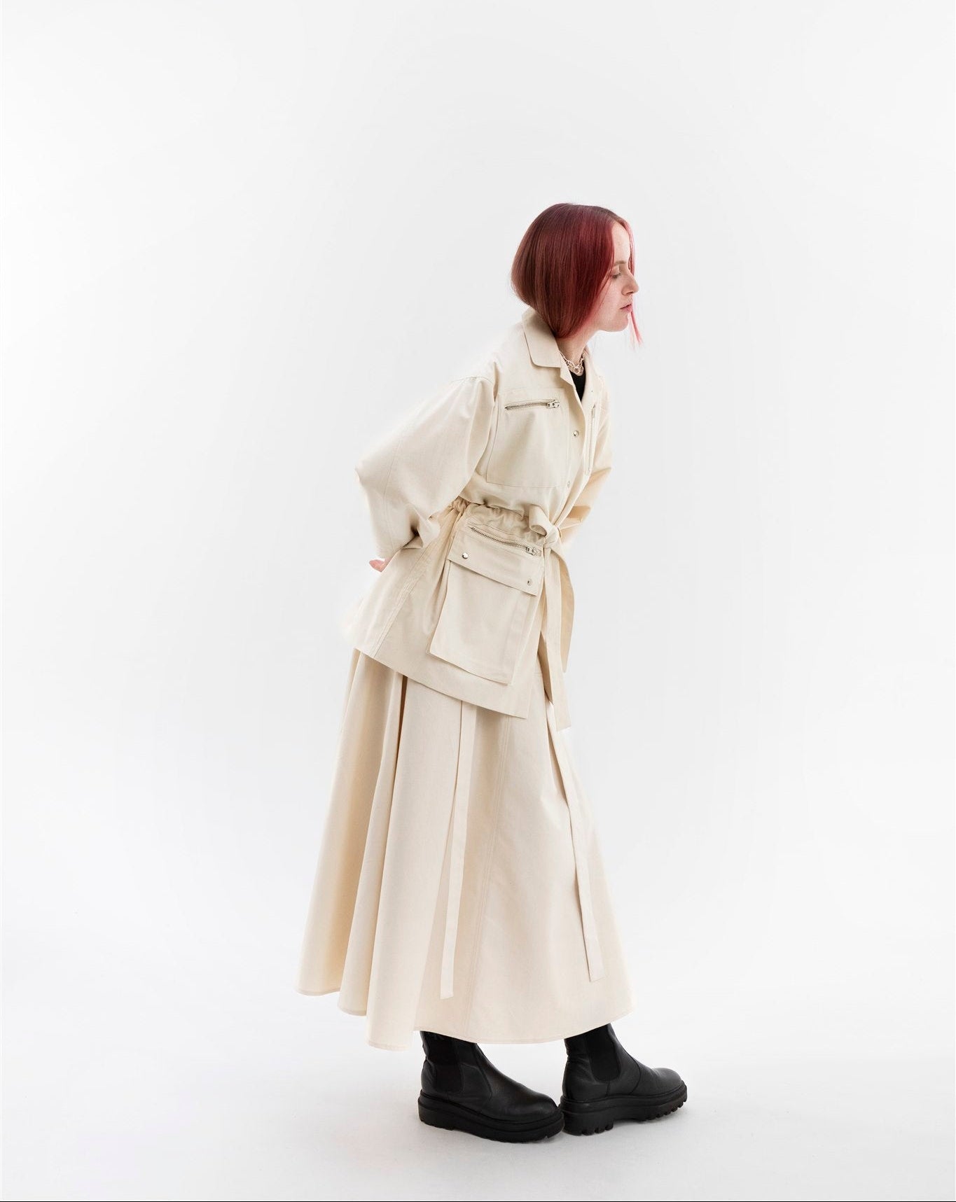 Gravity Field Jacket in natural seeded cotton canvas, worn cinched at the waist.