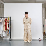 Gravity Field Jacket in natural seeded cotton canvas, worn cinched at the waist with full-length sleeves