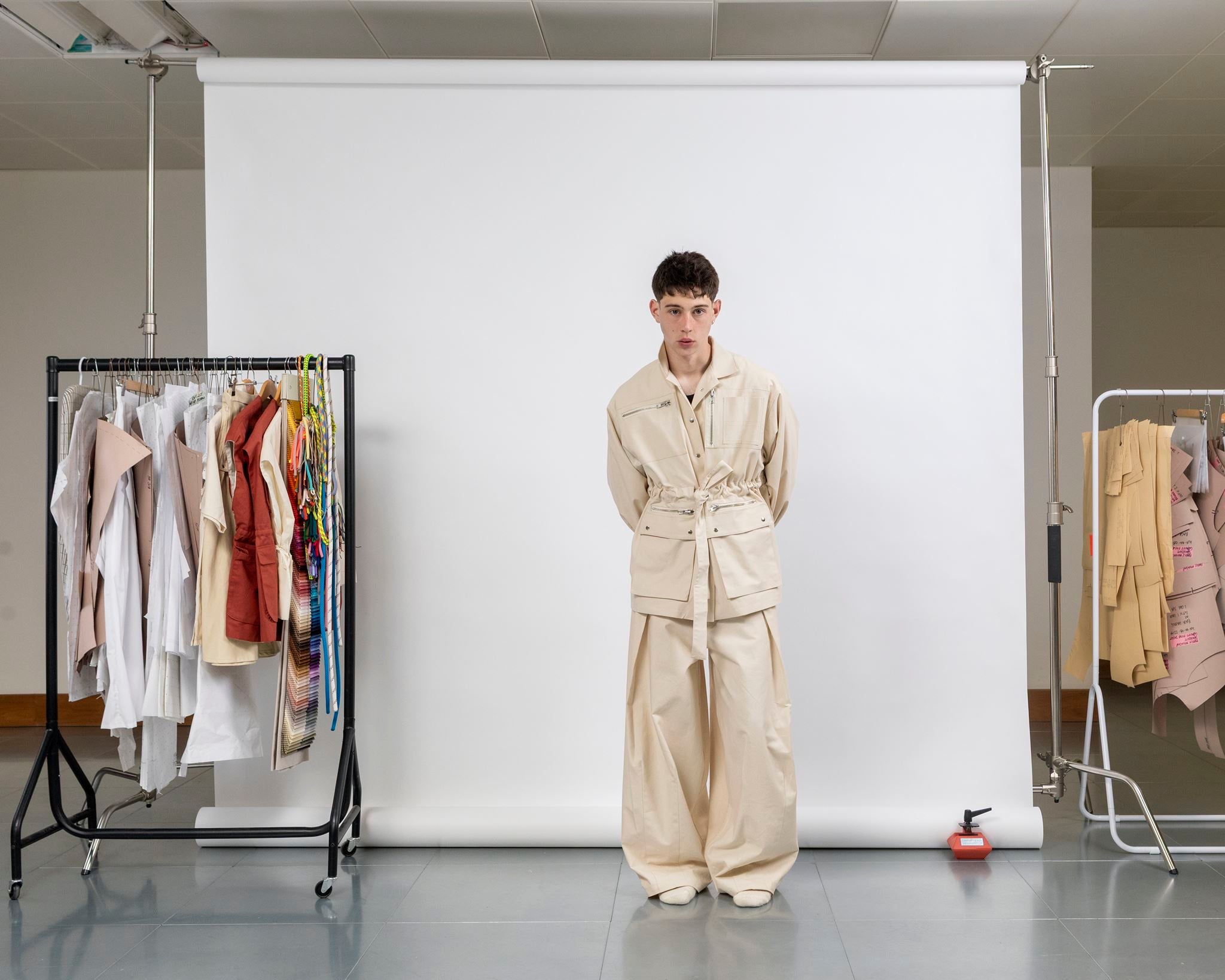 Gravity Field Jacket in natural seeded cotton canvas, worn cinched at the waist with full-length sleeves