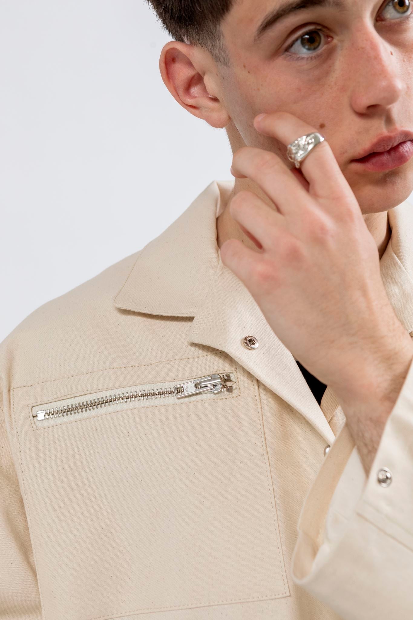 Gravity Field Jacket in natural seeded cotton canvas, showing stainless steel zip pocket and press studs